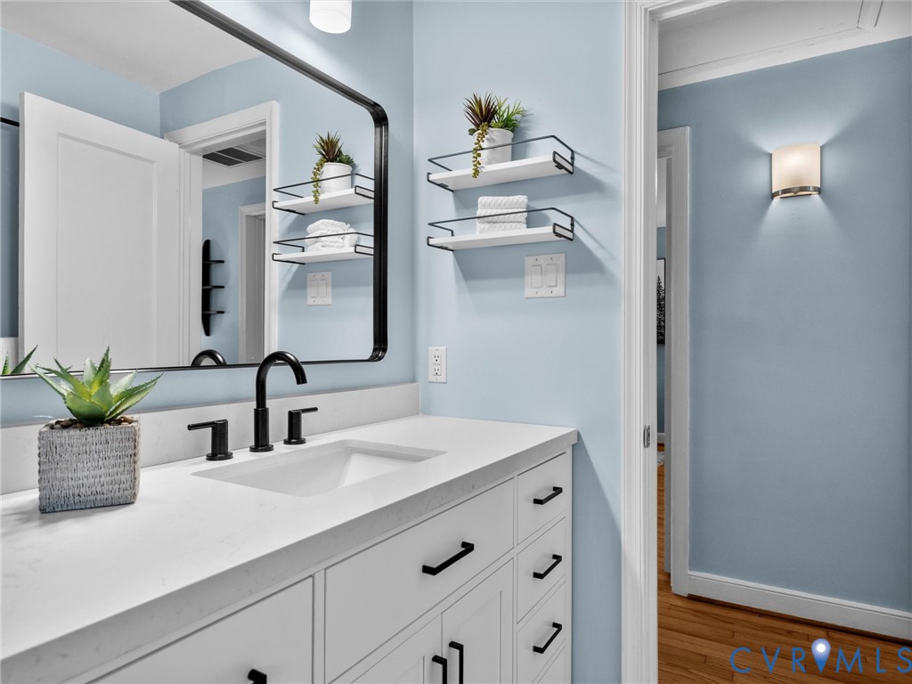 6715 Galaxie Road Henrico, VA 23228 - Photo 27 of 40 a bathroom with a sink and a mirror