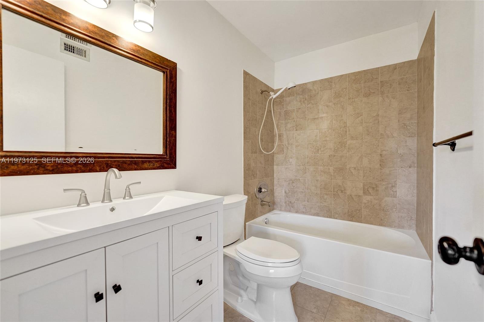 9340 Southwest 61st Way, Unit B Boca Raton, FL 33428 - Photo 12 of 25 a bathroom with a sink a toilet and shower