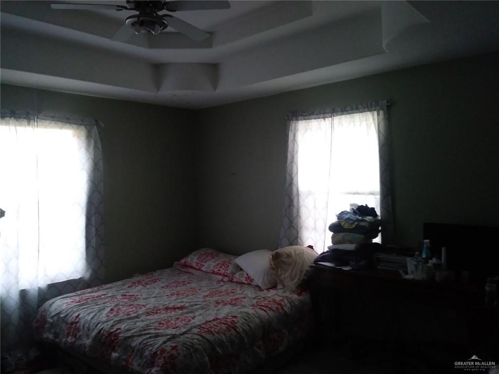 12705 East Monte Cristo Road Edinburg, TX 78542 - Photo 7 of 16 a bed sitting in a bedroom next to a window