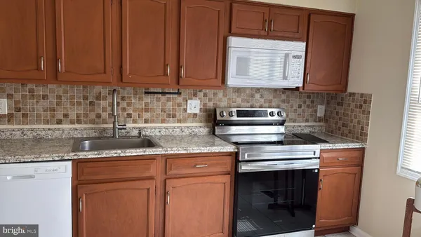 a kitchen with a stove and a microwave