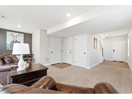 a bedroom with furniture and a lamp