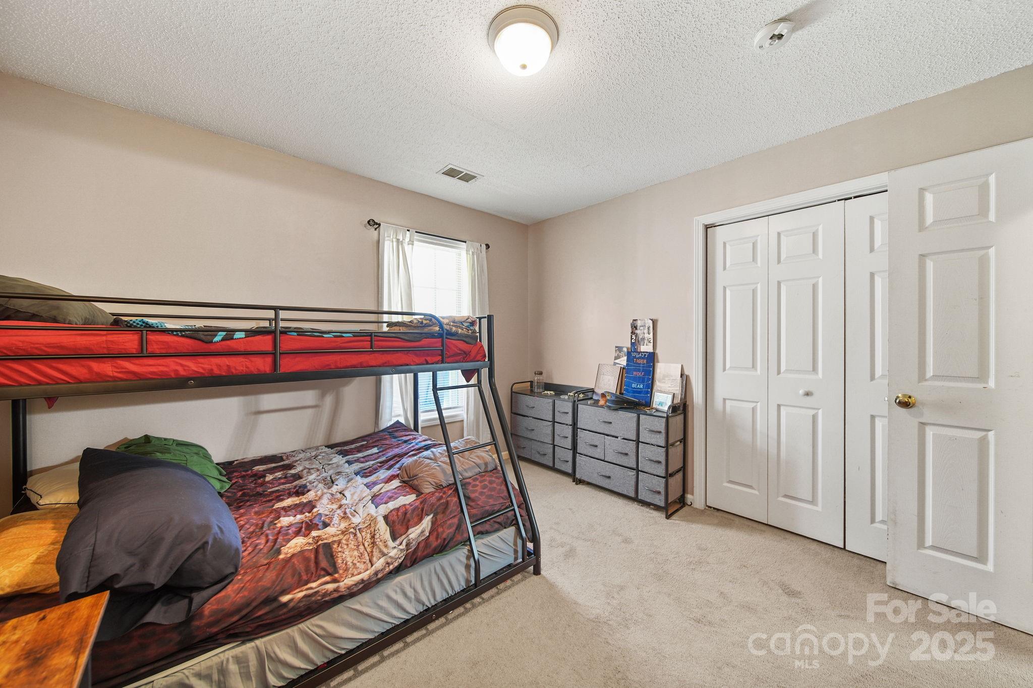 1723 Faulks Church Road Marshville, NC 28103 - Photo 11 of 27 a bedroom with a bed and a closet