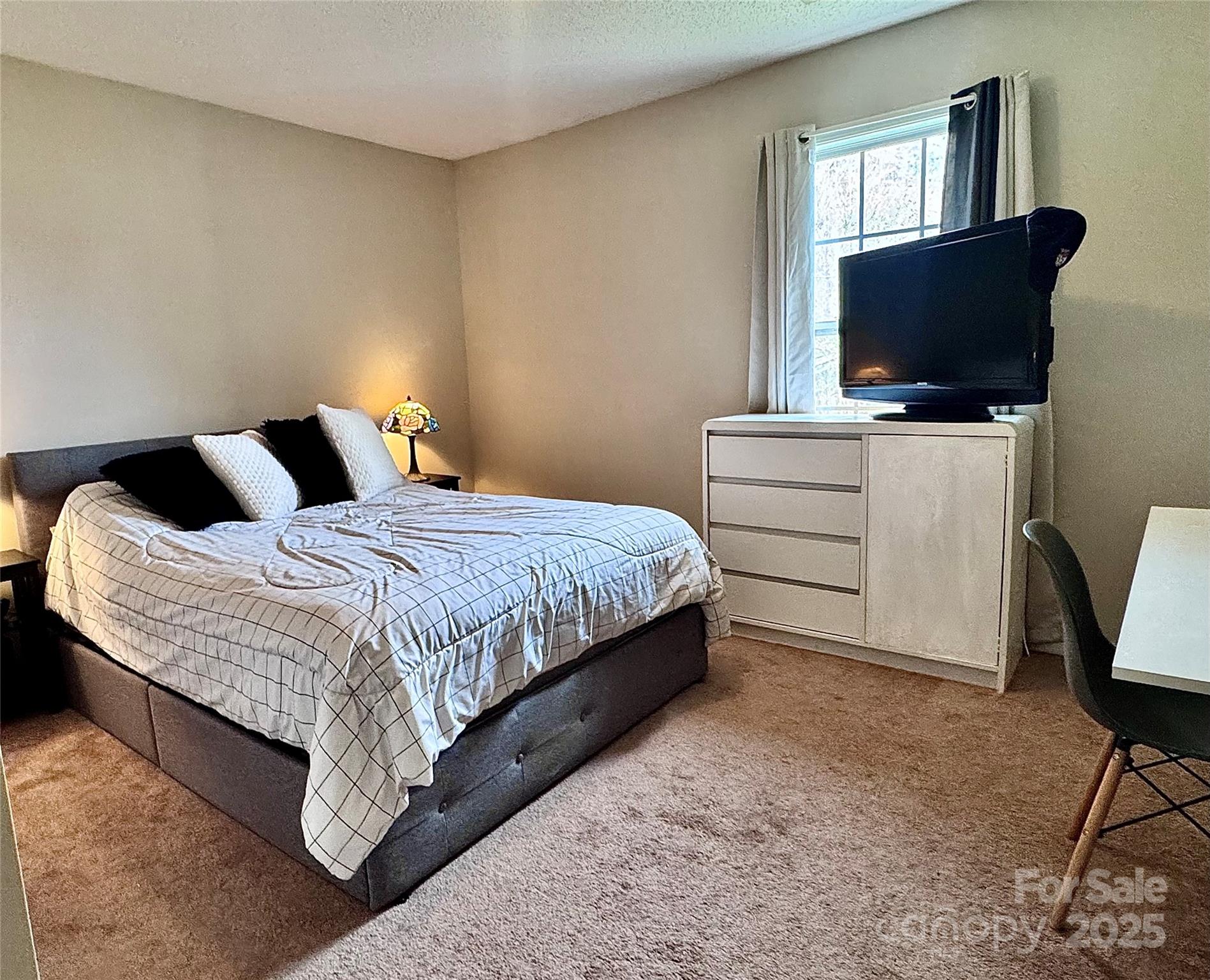 1723 Faulks Church Road Marshville, NC 28103 - Photo 13 of 27 a bedroom with a bed and a flat screen tv