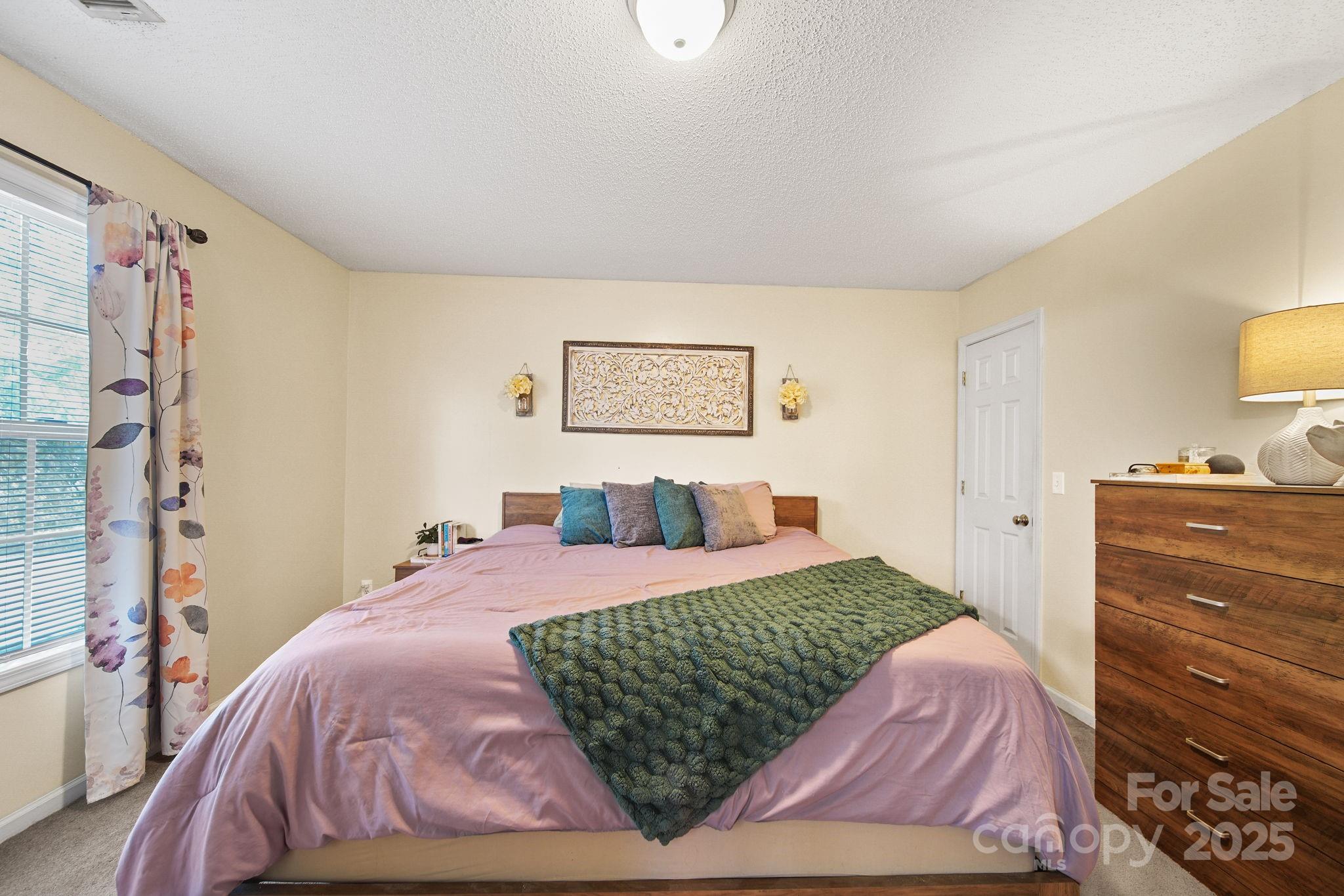 1723 Faulks Church Road Marshville, NC 28103 - Photo 16 of 27 a bedroom with a bed and wooden floor