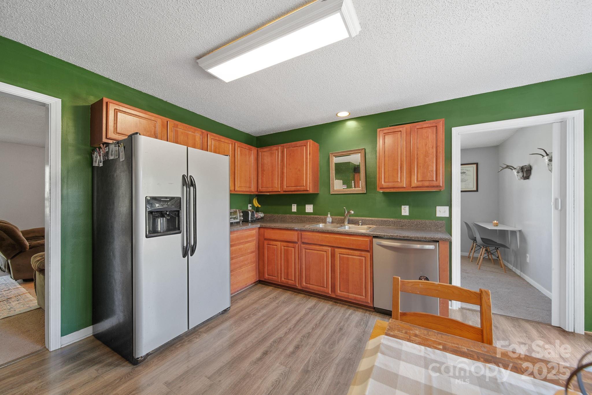 1723 Faulks Church Road Marshville, NC 28103 - Photo 22 of 27 a kitchen with stainless steel appliances granite countertop a refrigerator and a sink