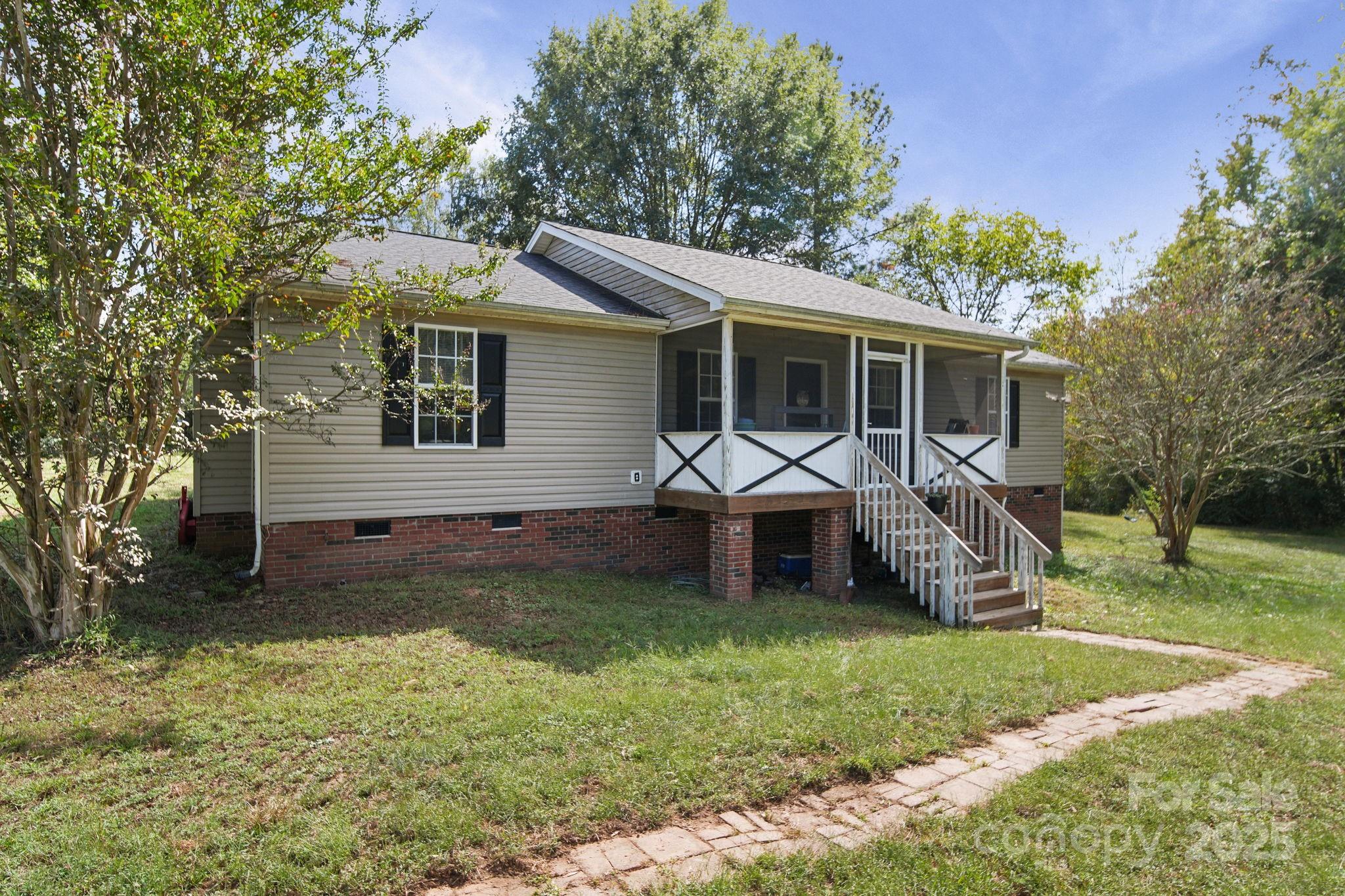 1723 Faulks Church Road Marshville, NC 28103 - Photo 3 of 27 a front view of house with a garden and trees