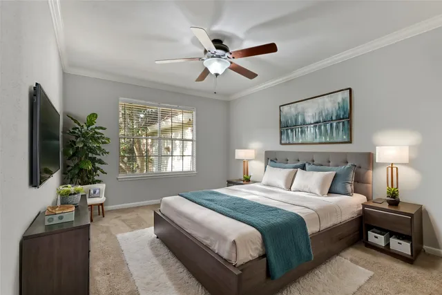 a bedroom with a bed and a chandelier