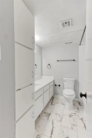 a bathroom with a toilet sink and tub