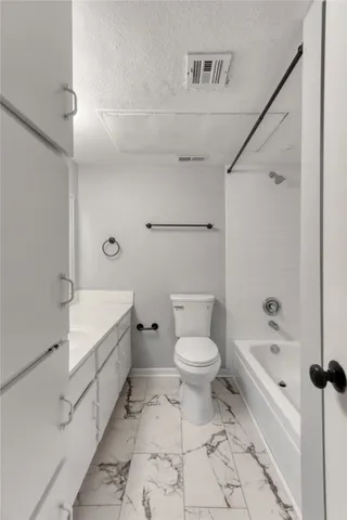 a bathroom with a toilet and a bathtub