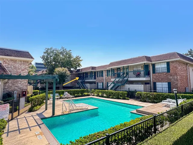 a view of a house with swimming pool and sitting area