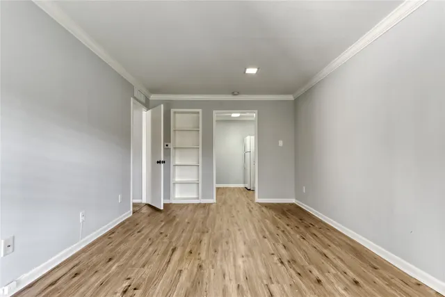 a view of wooden floor and windows in a room