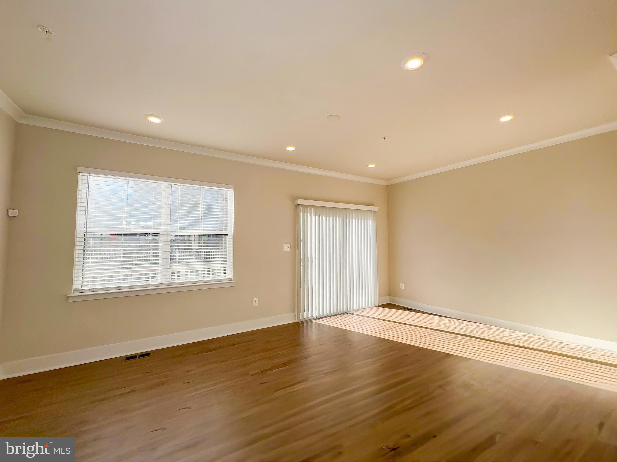 822 Teacher MItchell Road Glen Burnie, MD 21060 - Photo 11 of 53 an empty room with wooden floor and windows