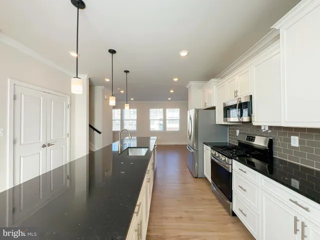 a large kitchen with lots of counter space and stainless steel appliances