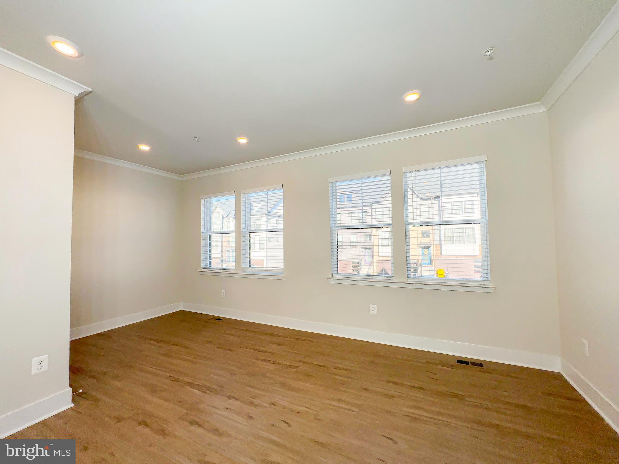 822 Teacher MItchell Road Glen Burnie, MD 21060 - Photo 20 of 53 an empty room with wooden floor and windows