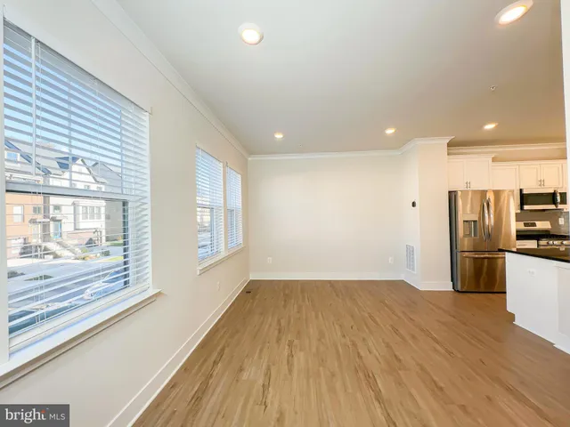 a view of a kitchen with wooden floor and a kitchen