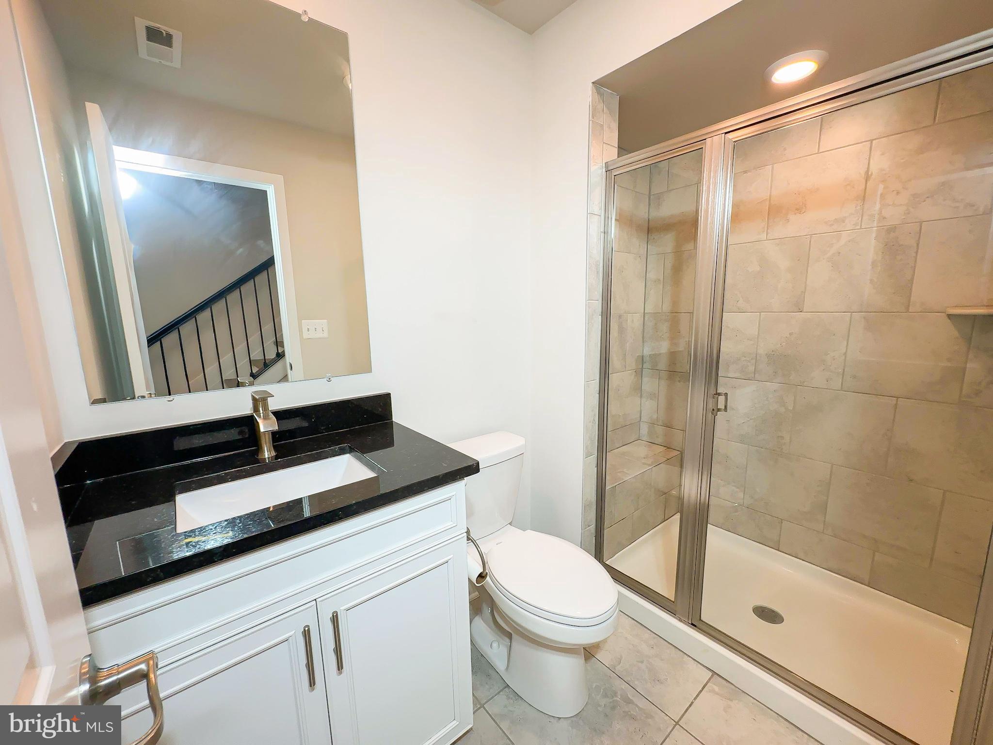 822 Teacher MItchell Road Glen Burnie, MD 21060 - Photo 25 of 53 a bathroom with a sink a toilet a mirror and shower