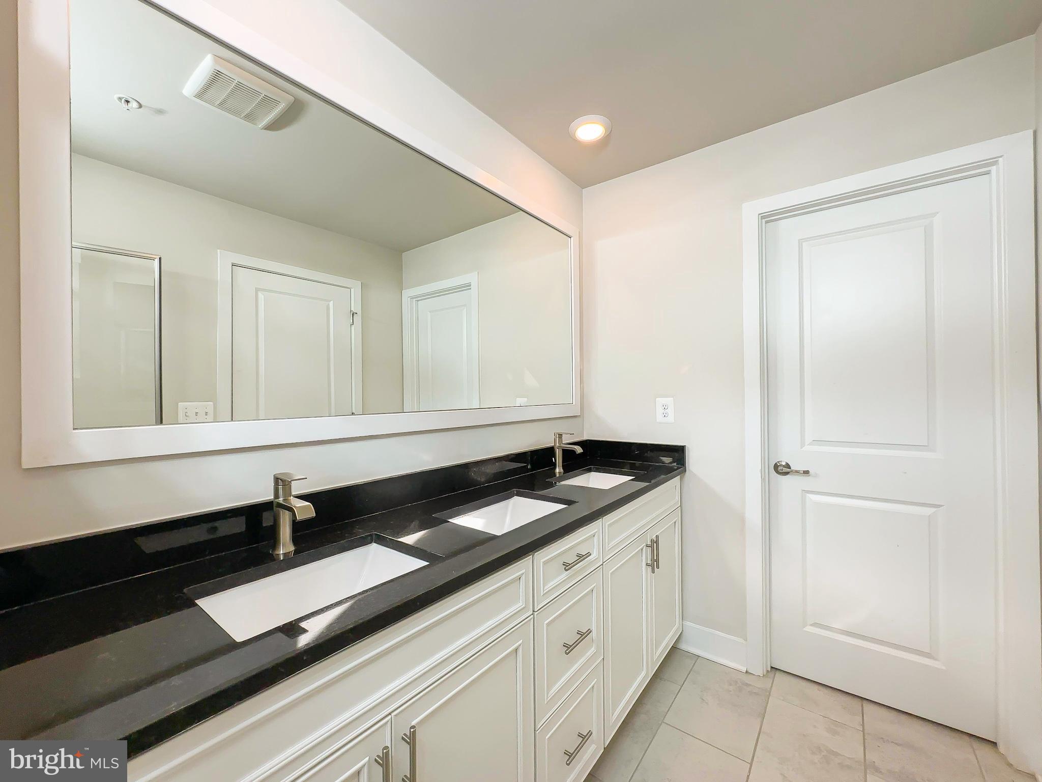 822 Teacher MItchell Road Glen Burnie, MD 21060 - Photo 31 of 53 a bathroom with a sink and a mirror