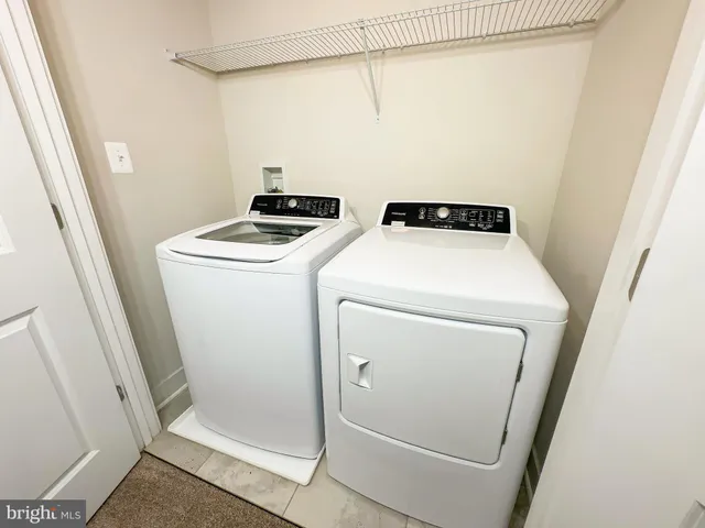 a bathroom with a granite countertop sink a toilet a mirror and bathtub
