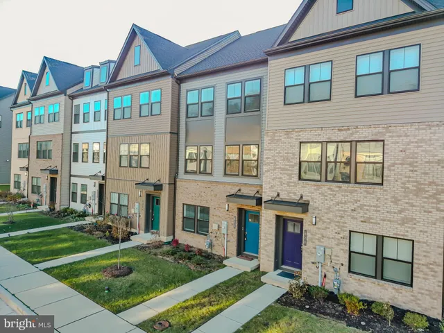 an aerial view of a house with swimming pool and a yard