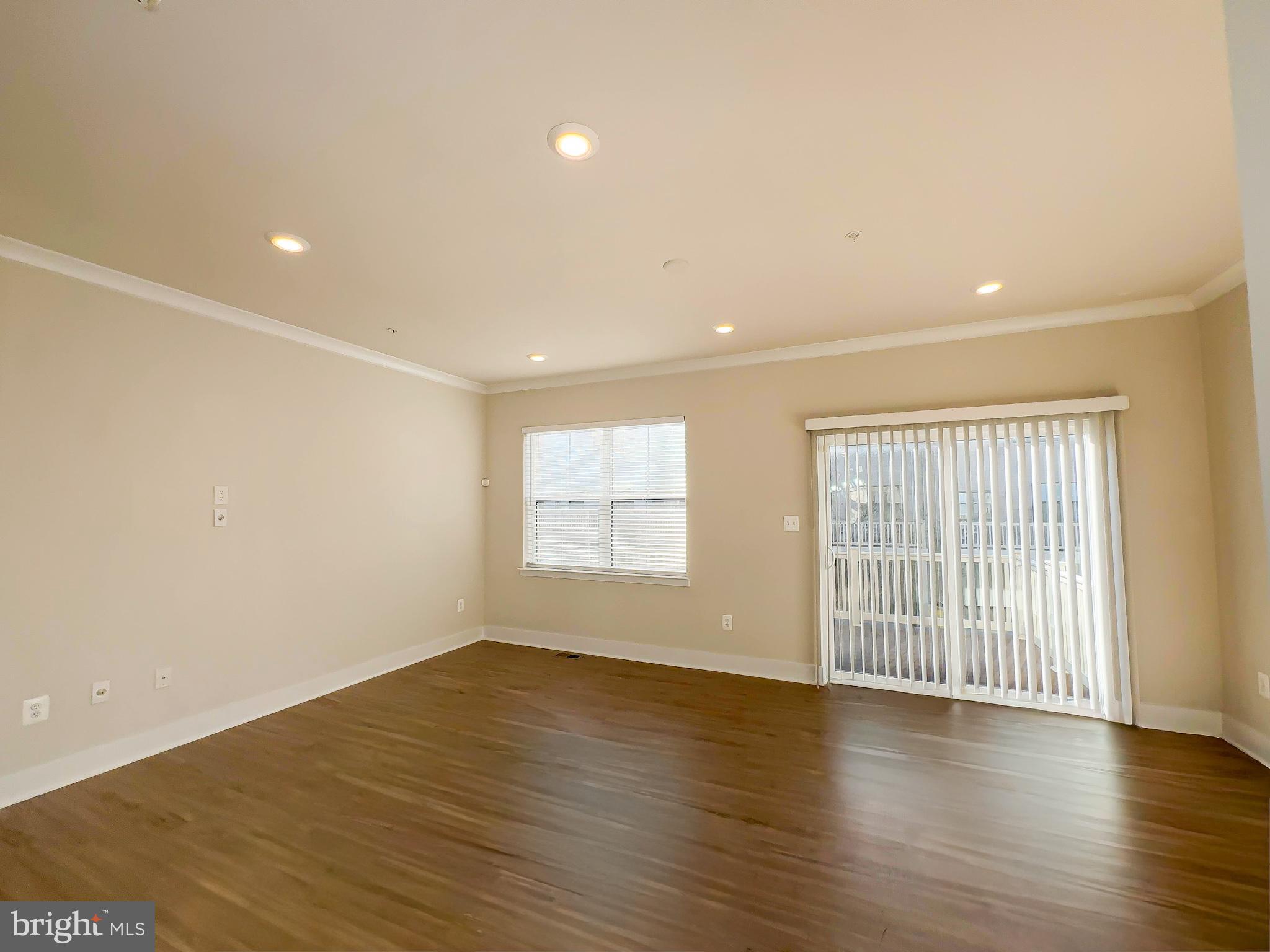 822 Teacher MItchell Road Glen Burnie, MD 21060 - Photo 9 of 53 a view of an empty room with wooden floor and a window