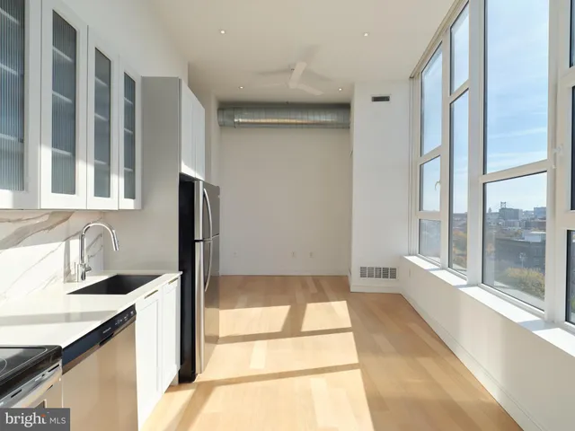 a bathroom with a granite countertop sink and a bathtub