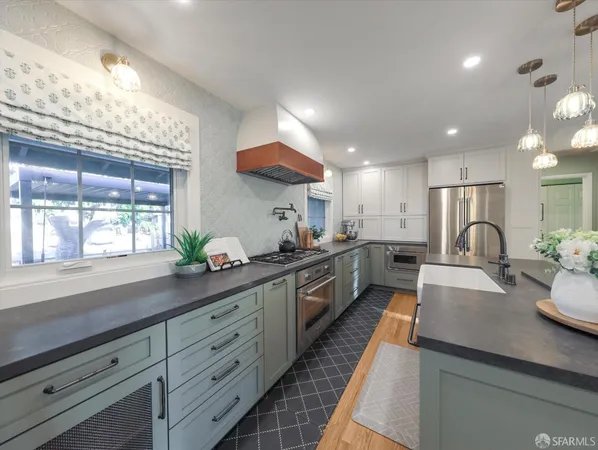 a large kitchen with granite countertop lots of counter space and window