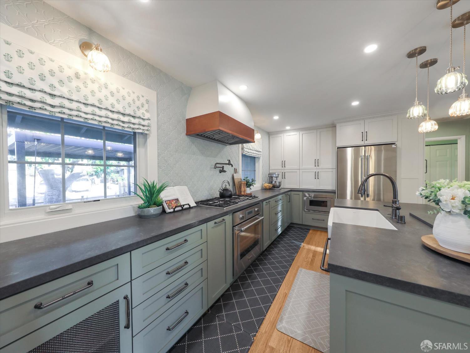 a large kitchen with granite countertop lots of counter space and window