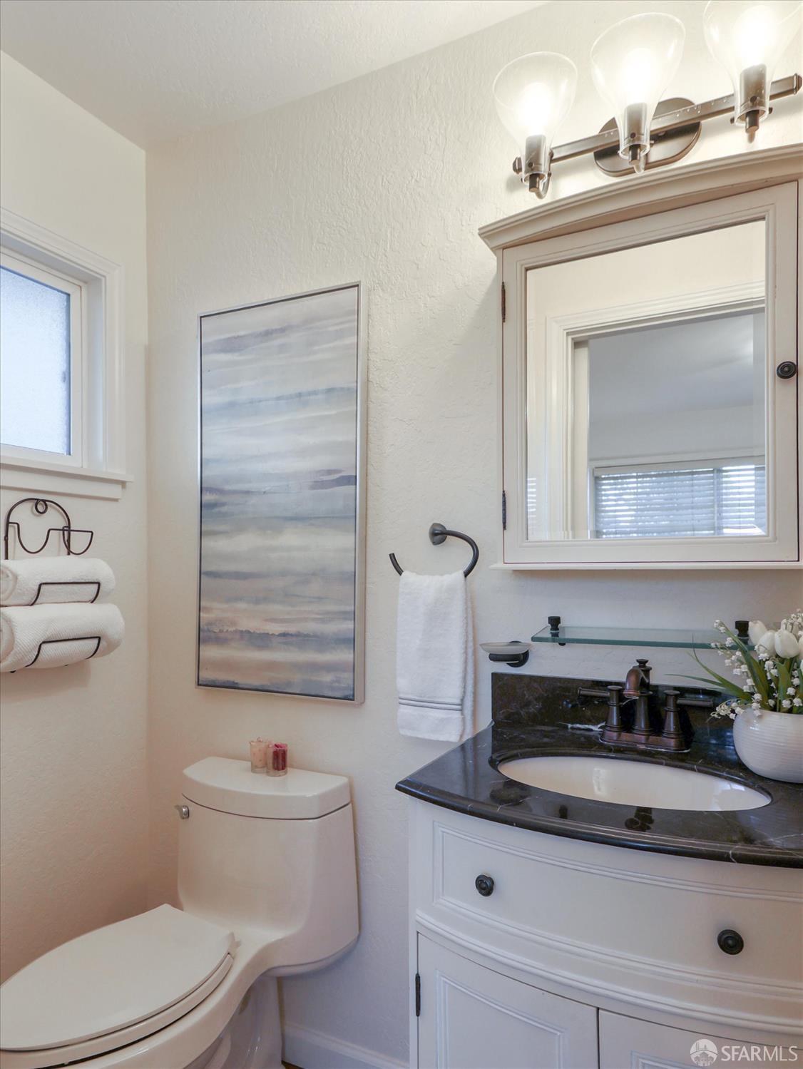 1773 Pinetree Court Concord, CA 94521 - Photo 17 of 37 a bathroom with a toilet a sink and mirror