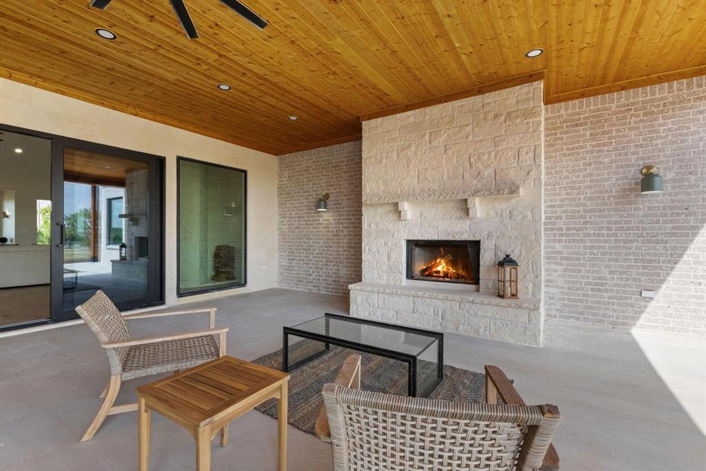 6505 County Road 1126B Godley, TX 76044 - Photo 33 of 39 View of patio featuring an outdoor living space witha fireplace