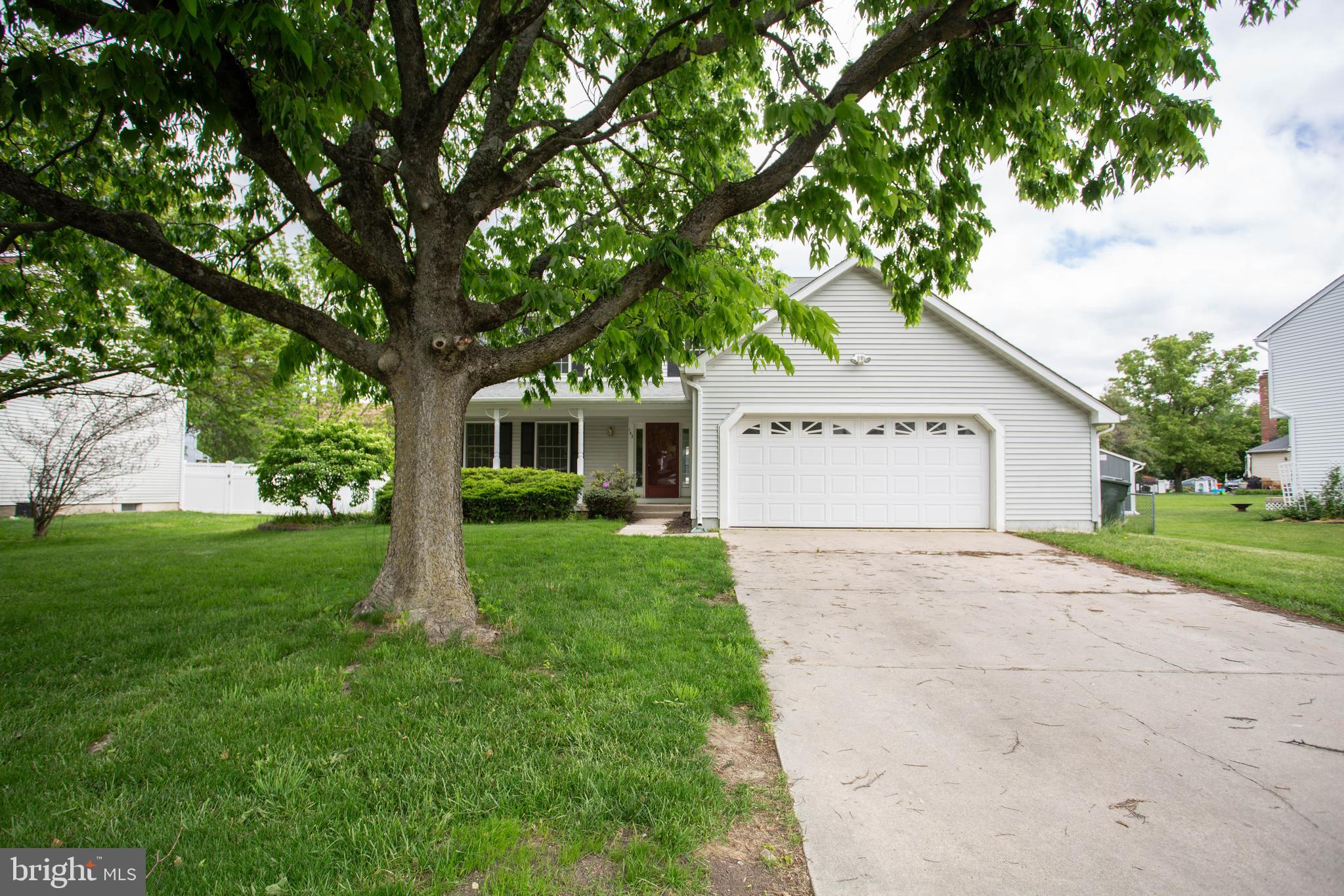 a view of a house with a yard and tree s