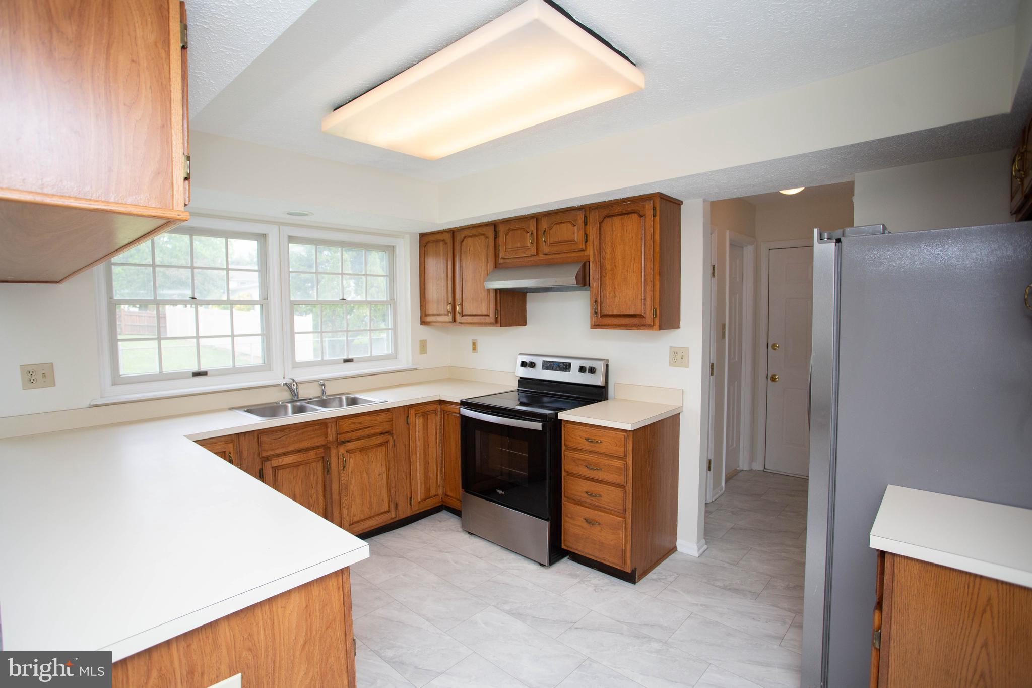 143 Rambling Road Lumberton, NJ 08048 - Photo 11 of 54 a kitchen with stainless steel appliances granite countertop a sink stove and refrigerator