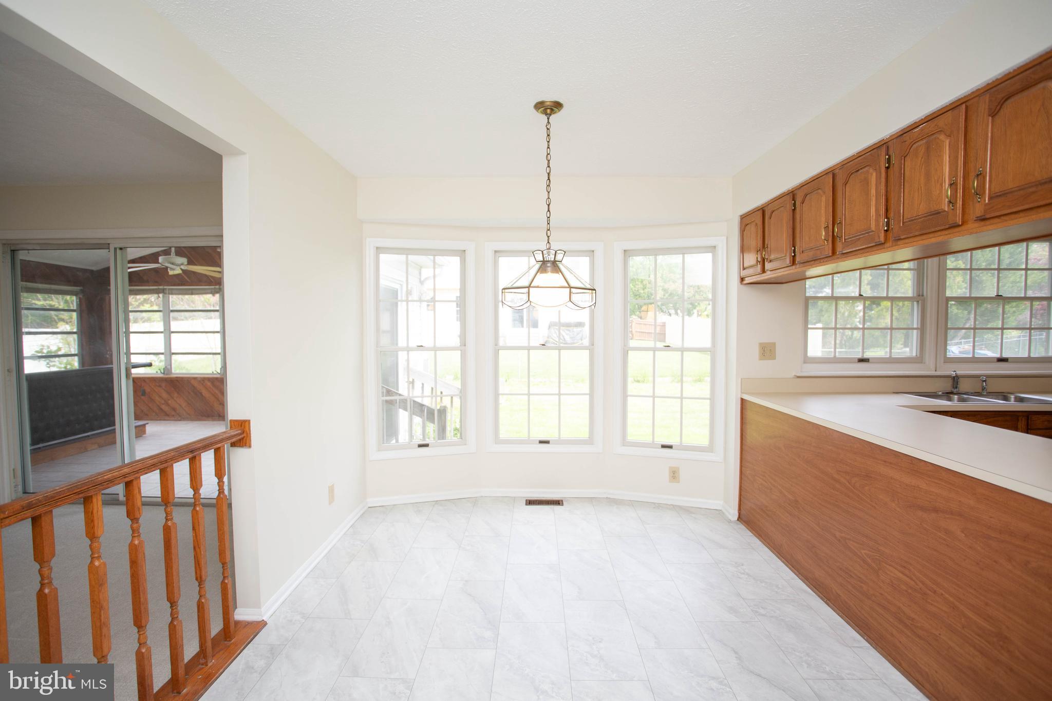 143 Rambling Road Lumberton, NJ 08048 - Photo 16 of 54 a large white kitchen with granite countertop a large window and a white counter top
