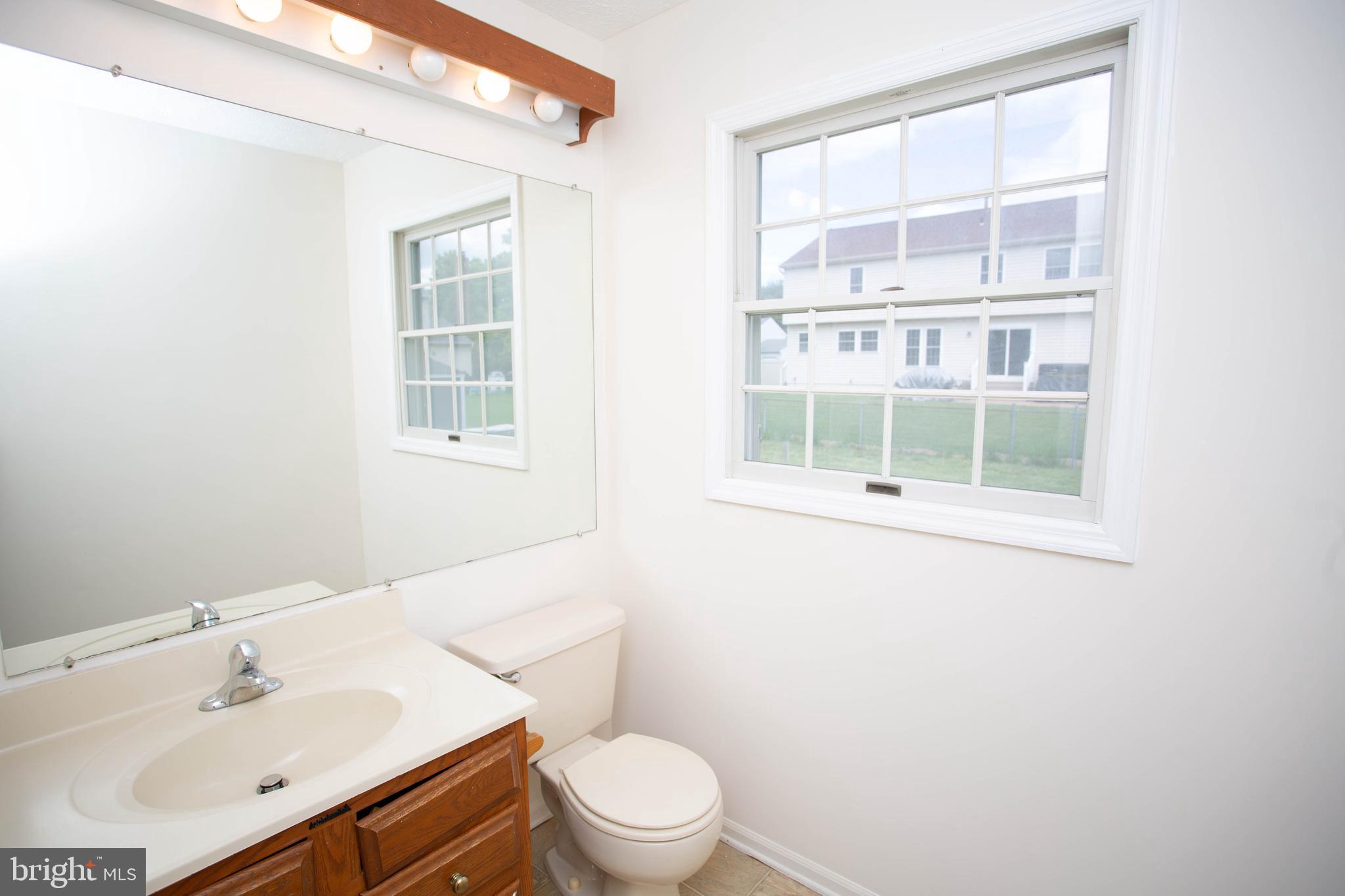 143 Rambling Road Lumberton, NJ 08048 - Photo 20 of 54 a bathroom with a sink a toilet and a window