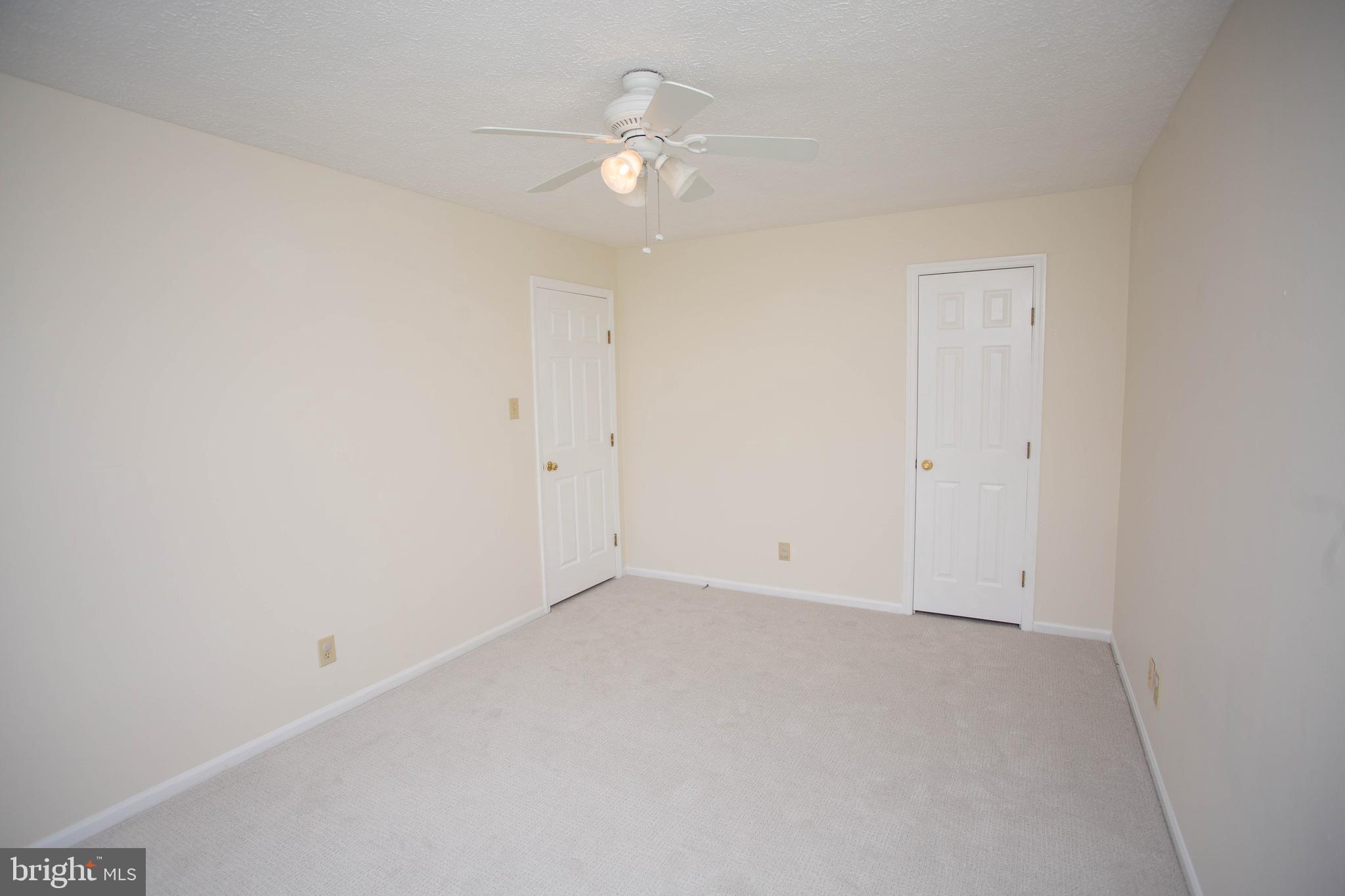 143 Rambling Road Lumberton, NJ 08048 - Photo 39 of 54 an empty room with a ceiling fan and a window
