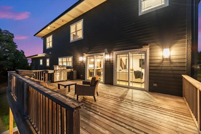 an aerial view of a house with a garden and lake view