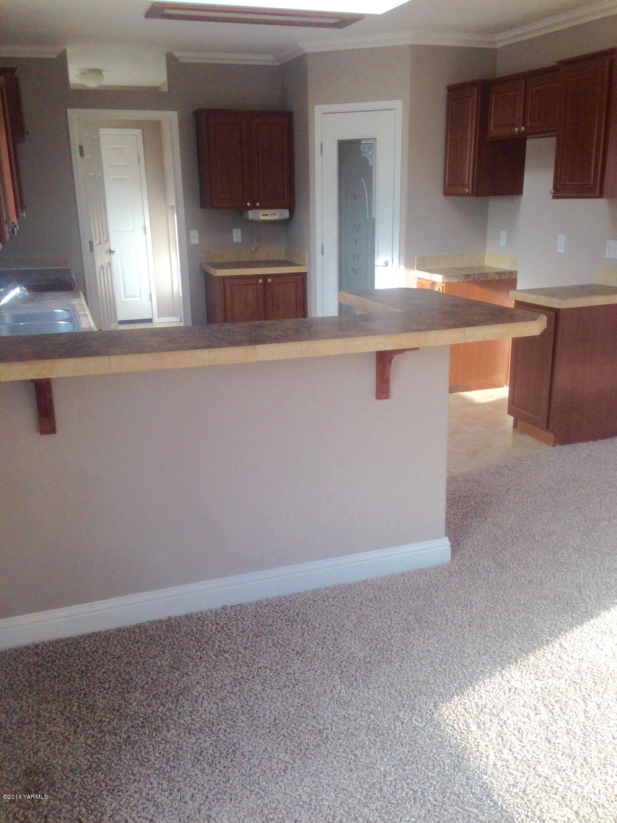100 Ranger Road Naches, WA 98937 - Photo 5 of 10 a kitchen with granite countertop a sink and a stove top oven