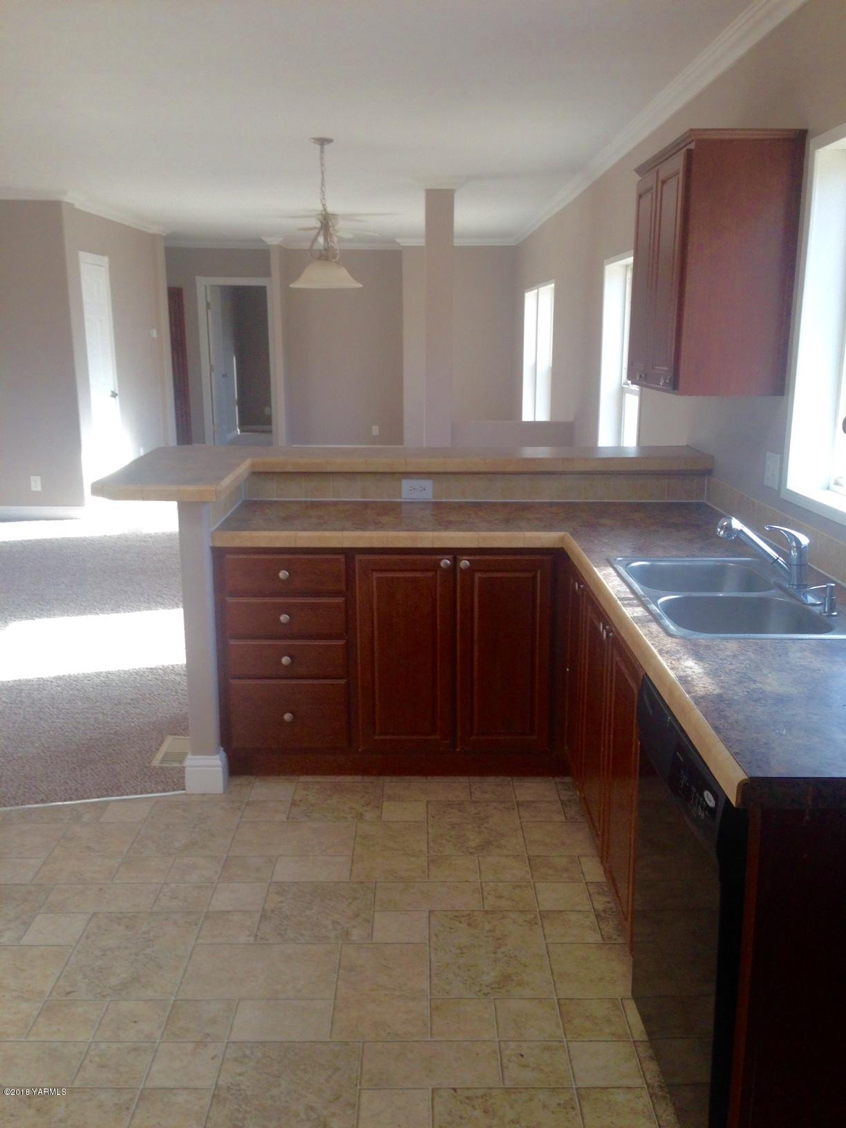 100 Ranger Road Naches, WA 98937 - Photo 6 of 10 a bathroom with a granite countertop sink and a mirror