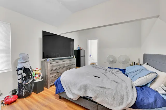 a bedroom with a bed and a flat screen tv