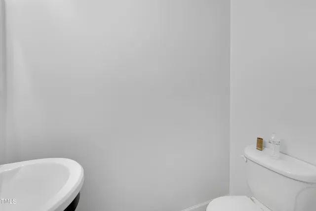 a white toilet sitting next to a white sink