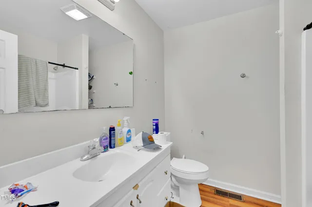 a bathroom with a sink toilet and a mirror