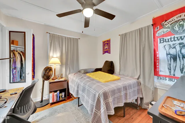 a bedroom with bed and a chandelier