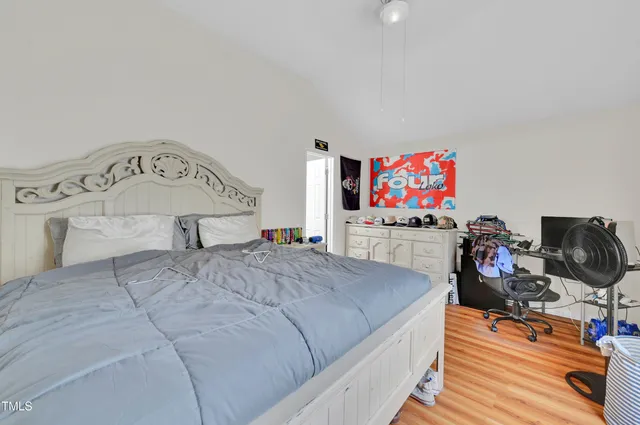 a bedroom with a bed and flat screen tv
