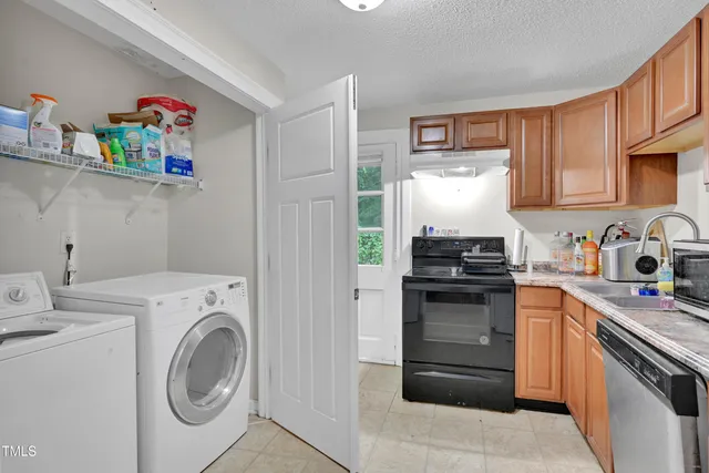 a kitchen with a sink and a stove top oven