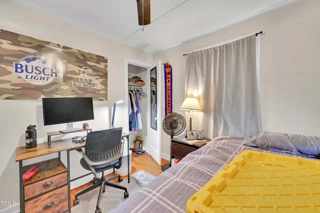a bedroom with furniture and a flat screen tv