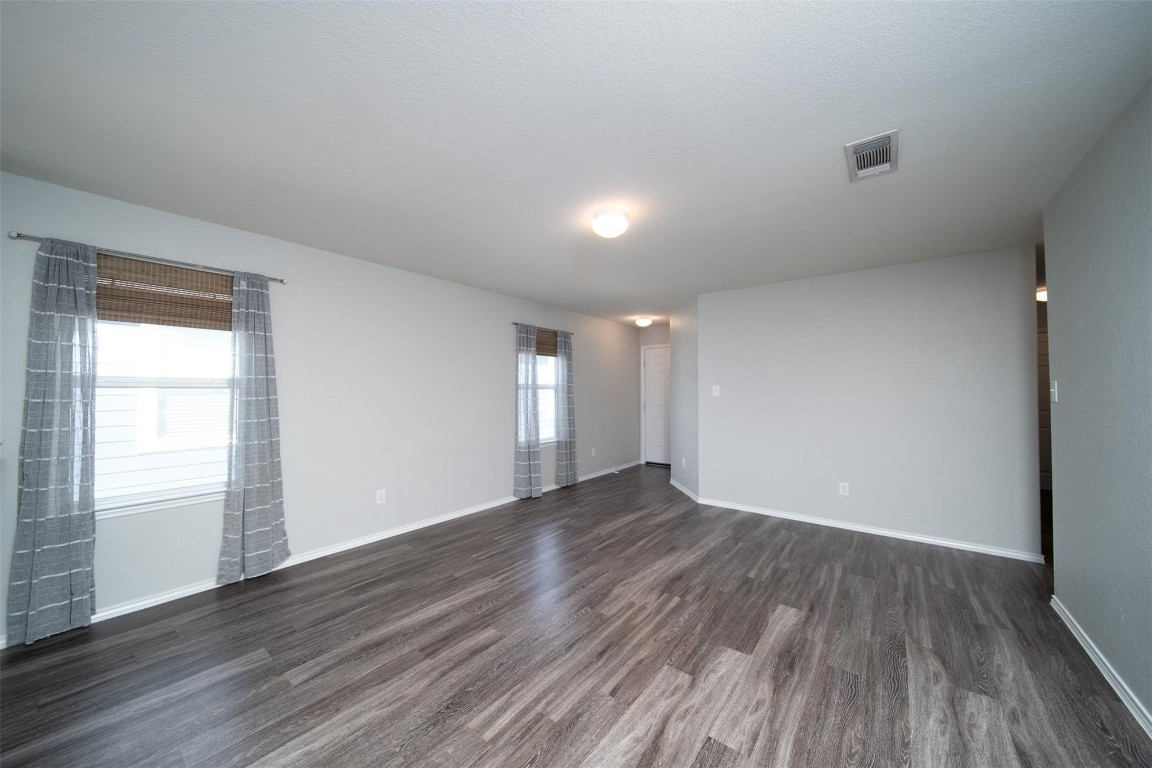 24023 Swather Way Hockley, TX 77447 - Photo 12 of 26 a view of an empty room with wooden floor and a window