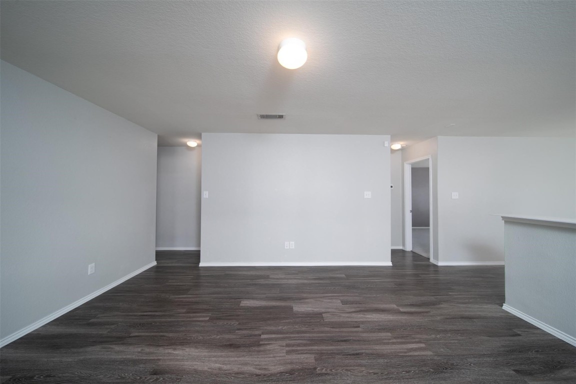24023 Swather Way Hockley, TX 77447 - Photo 13 of 26 a view of an empty room with wooden floor