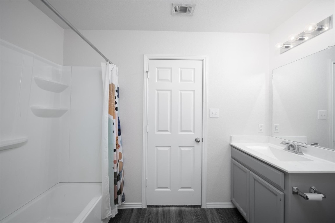 24023 Swather Way Hockley, TX 77447 - Photo 16 of 26 a bathroom with a sink a mirror and a bathtub