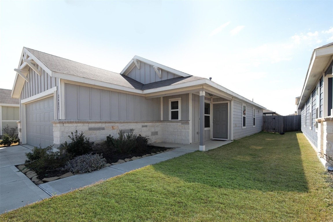 24023 Swather Way Hockley, TX 77447 - Photo 3 of 26 a front view of a house with garden