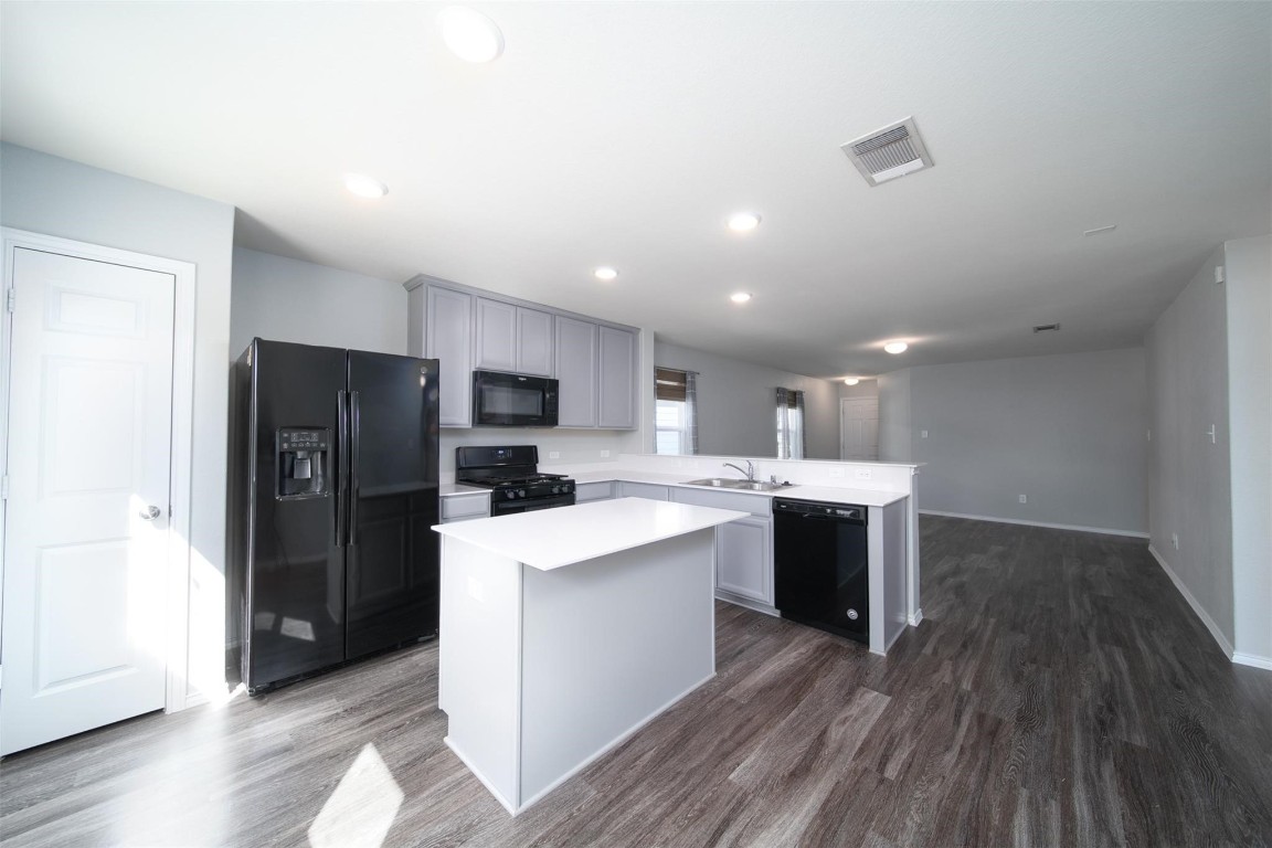 24023 Swather Way Hockley, TX 77447 - Photo 10 of 26 a kitchen with stainless steel appliances a refrigerator sink and microwave
