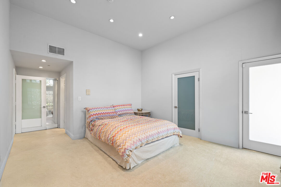 11822 Goshen Avenue, Unit 301 Los Angeles, CA 90049 - Photo 14 of 29 a bedroom with a bed and a night stand